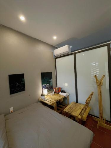 a bedroom with a bed and a table and chairs at BG Stone Homestay in Mộc Châu