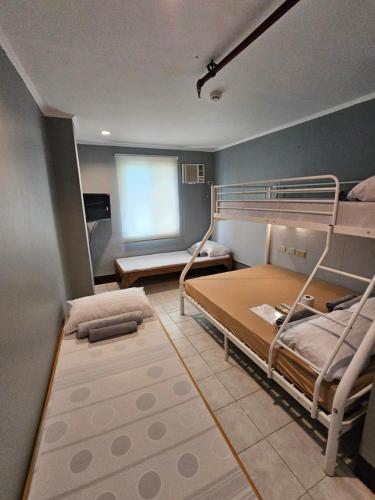 a room with two bunk beds and a window at Ciello Accomodation in Cagayan de Oro