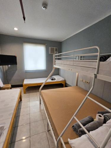a room with two bunk beds and a window at Ciello Accomodation in Cagayan de Oro