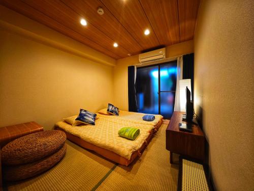 a small bedroom with a bed and a window at 3BR Private House with Open-air Bath & garden, 5min to subway! 柚苑YUEN in Osaka