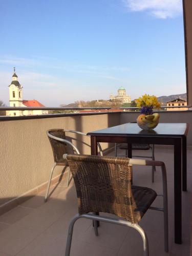 a table and chairs on a balcony with a view at Central House in Štúrovo