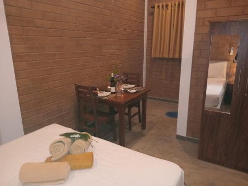 a room with a table and a table and a room with a table at Villa Sol in Kamburugamuwa