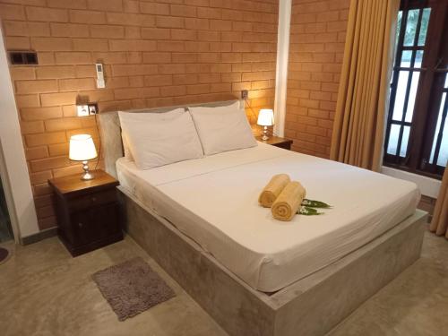 a bed with two towels on it in a bedroom at Villa Sol in Kamburugamuwa