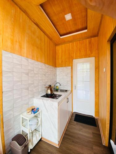 a small kitchen with a sink and a counter at Kahiyang Villa Dieng in Banjarnegara
