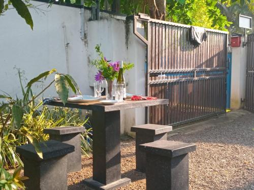 a table with flowers on it in a garden at Villa Sol in Kamburugamuwa
