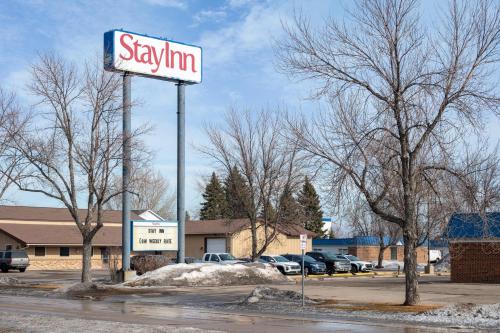 a sign for a skimim store in a parking lot at StayInn Grand Forks in Grand Forks