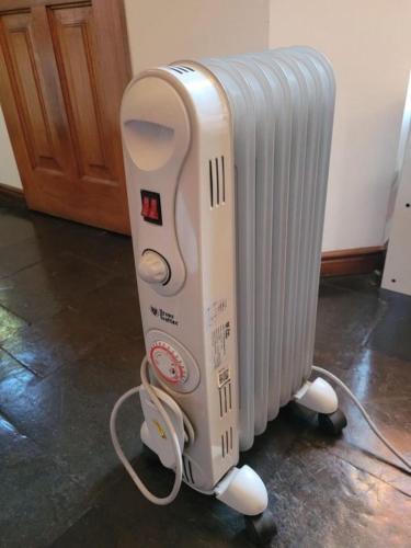 a hair dryer is standing next to a radiator at Cabaña central a pasos del terminal in Valdivia