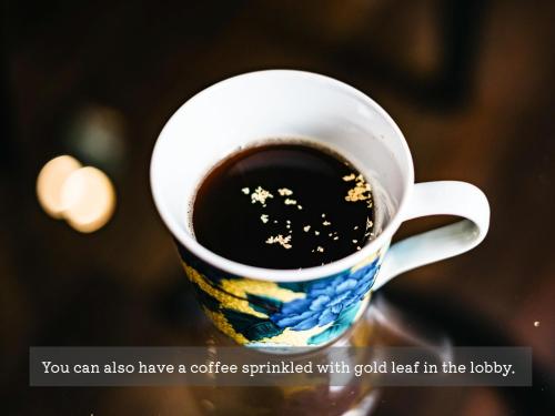 a cup of coffee with gold stars on it at Hotel Resol Trinity Kanazawa in Kanazawa