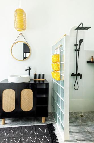 a bathroom with a sink and a mirror at Stylish Flat and Old Town View in Luang Prabang