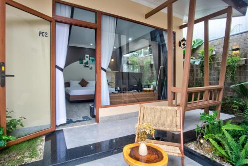a home with large glass windows and a chair at House of Pi Pleiku in Pleiku