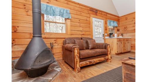 a living room with a stove and a chair at Solitude in Bryson City