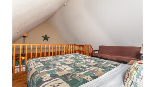 a bedroom with a bed with a quilt on it at Solitude in Bryson City