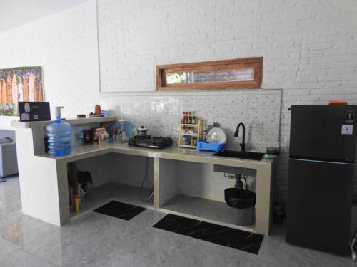 a kitchen with a desk and a refrigerator at The middle Surf house in Airsatang