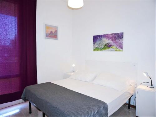 a bedroom with a white bed and a purple window at Charming villa in Porto Santa Margherita with private garden in Porto Santa Margherita di Caorle