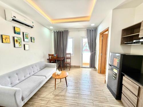 a living room with a couch and a table at Blue Sea Luxury Hotel & Apartment Vũng Tàu in Vung Tau