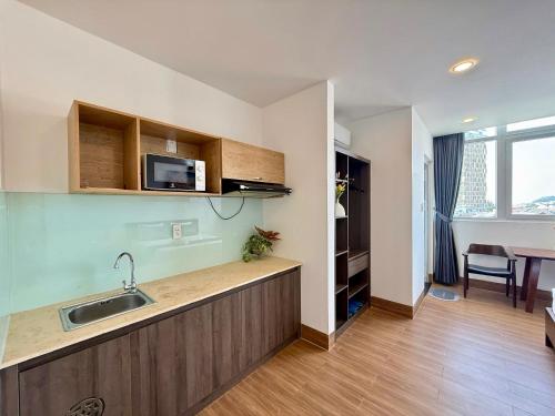 a kitchen with a sink and a counter top at Blue Sea Luxury Hotel & Apartment Vũng Tàu in Vung Tau