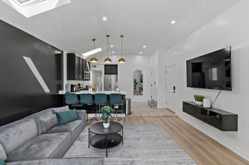a living room and kitchen with a couch and a table at The Haven, Great Location near Downtown, Medical District and United Center in Chicago