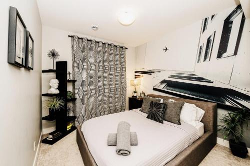 a small bedroom with a bed and a piano at Modern suite near Airport Hospital Henday Town Ctr in Nisku
