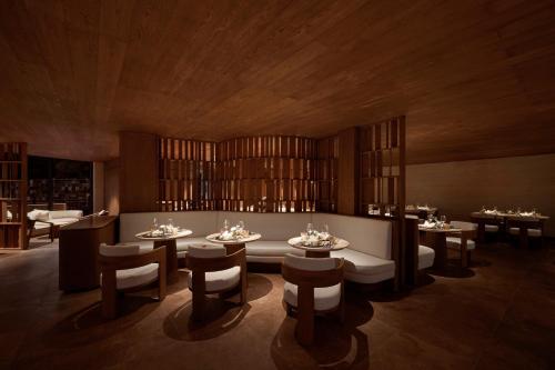 a dining room with tables and chairs with glasses on them at Garrya Mù Cang Chải in Mù Cang Chải
