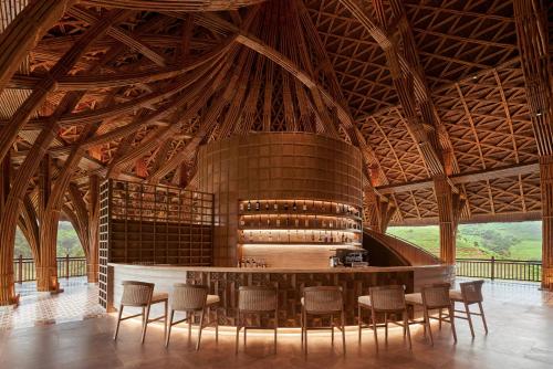 a large room with a bar in a wooden building at Garrya Mù Cang Chải in Mù Cang Chải