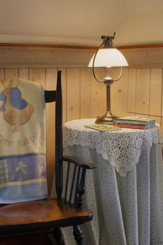 a table with a lamp and a table with a chair at Isaiah Jones Homestead Bed and Breakfast in Sandwich
