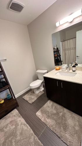 a bathroom with a toilet and a sink and a mirror at Private Room and Bathroom in Los Angeles