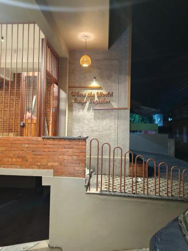 a building with a balcony with a sign on it at Zostay Urban Retreat Deluxe Rooms & Premium Dorms in Manjeri