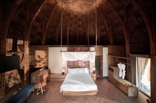 a bedroom with a bed in a room with a ceiling at Garrya Mù Cang Chải in Mù Cang Chải