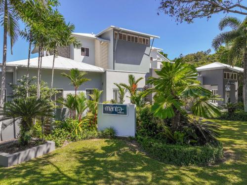a house with a sign in front of it at Mantra Aqueous on Port in Port Douglas