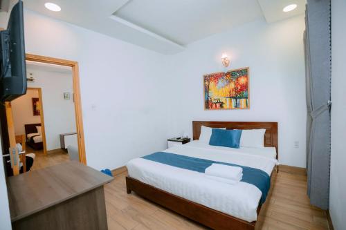 a bedroom with a large bed and a television at Blue Sea Luxury Hotel & Apartment Vũng Tàu in Vung Tau