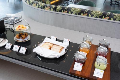 a table with sandwiches and other food items on it at Queensland Hotel Bangkok in Bangkok