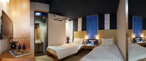 a room with two beds in a room at Uncle Loy's Boutique House in Bangkok