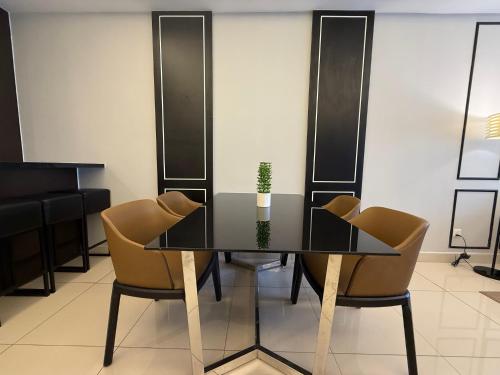 a dining room with a table and chairs at QUINCE HOME GRAND ION DELEMEN GENTING HIGHLANDs in Genting Highlands