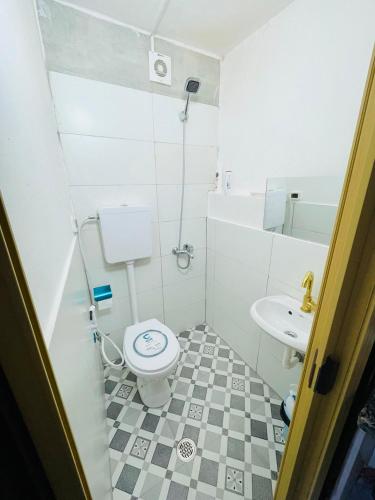 a small bathroom with a toilet and a sink at Alsharif family in Hebron