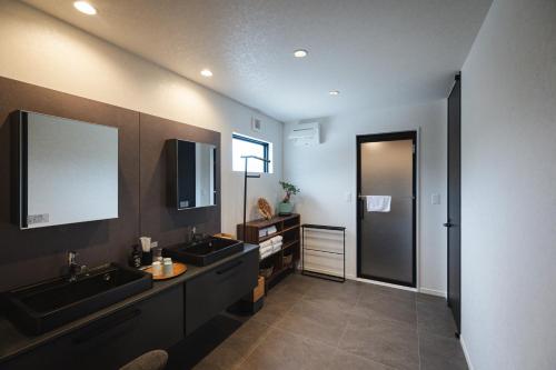 a bathroom with two sinks and a mirror at THE HERO VILLA 米原ビーチリゾートishigaki in Ishigaki Island