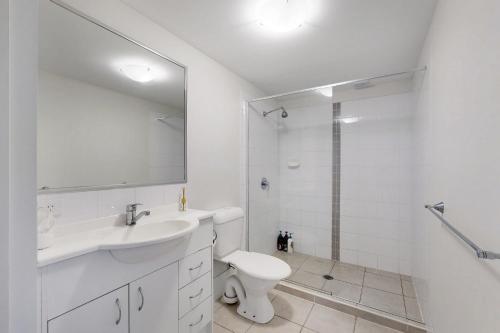 a bathroom with a sink and a toilet and a shower at Simple & Sweet Mango Hill Home - Big Patio in North Lakes