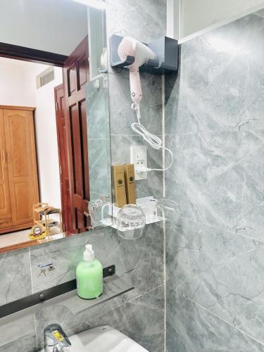 a bathroom with a sink and a mirror and a toilet at I Riverside B303 I Compact & Quiet Studio in Ho Chi Minh City