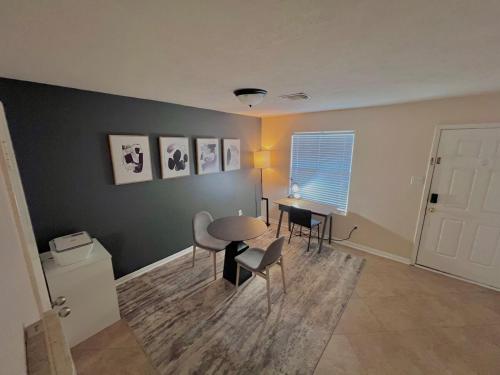 a living room with a table and chairs at Houston home near the Hobby Airport in Houston