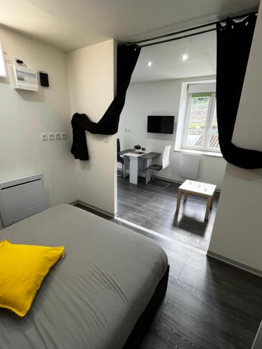 a bedroom with a large bed and a living room at KNUT-HOME Luxembourg in Knutange