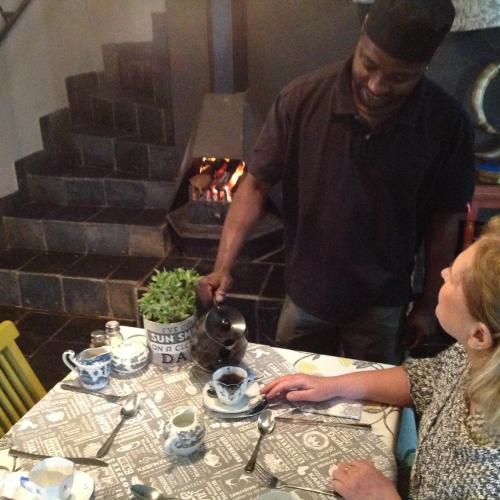 a man and a woman sitting at a table at Boord Guest House in Stellenbosch