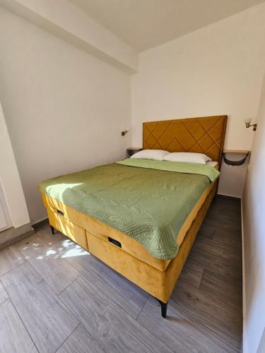 a bedroom with a large bed in a room at Apartments Danica in Petrovac na Moru