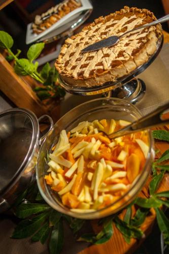 a table with a pot of food and a pie at Hotel Vai Moana in Hanga Roa