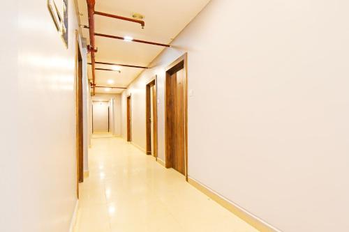 an empty corridor of a building with doors and a hallway at Super Townhouse Mancheswar Industrial Estate in Bhubaneshwar