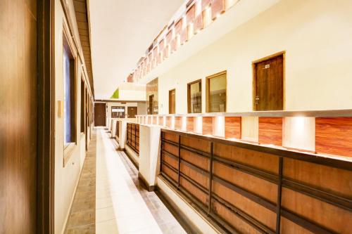 an empty hallway of a school building with wood at Super Townhouse Haibowal Chowk in Ludhiana