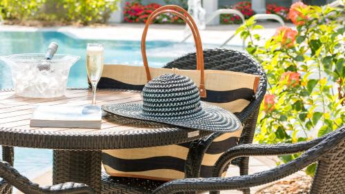 a hat sitting on a table next to a pool at Blue Flamingo Resort Key West in Key West