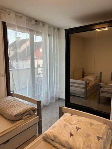 une chambre avec un grand miroir et un lit dans l'établissement Les Berges du Thiou Annecy Lac, à Annecy