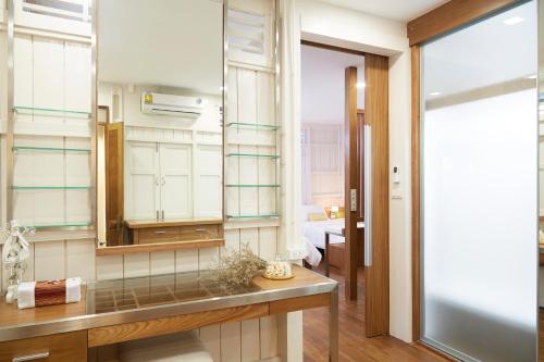a bathroom with a sink and a mirror at Uncle Loy's Boutique House in Bangkok