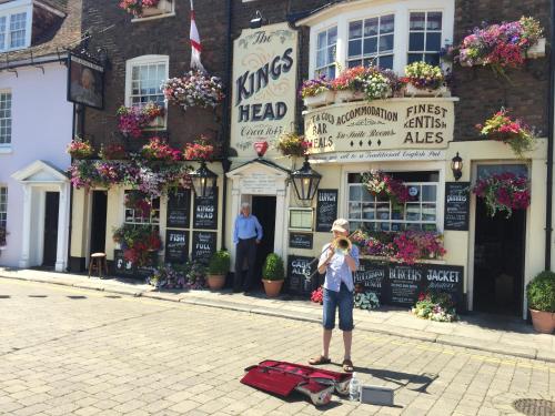 a woman standing in the street in front of a building at The Kings Head in Deal