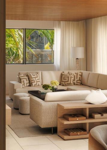 a living room with a couch and a table at One&Only Le Saint Géran, Mauritius in Belle Mare