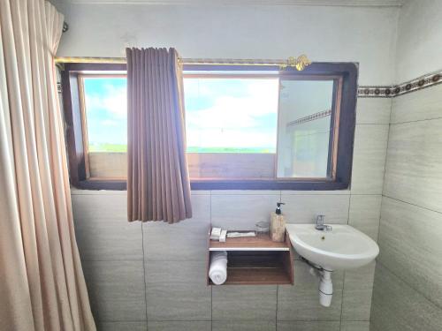 a bathroom with a sink and a window at Kelingking BMS Penida Hills Villa in Nusa Penida